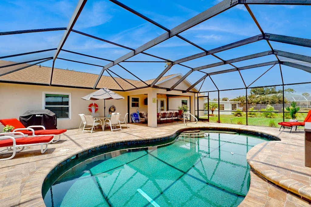 Inviting home with screened pool lovely patio & upgraded interior beach nearby