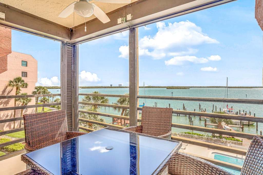 Bayfront condo with shared pool dock & water views snowbird friendly