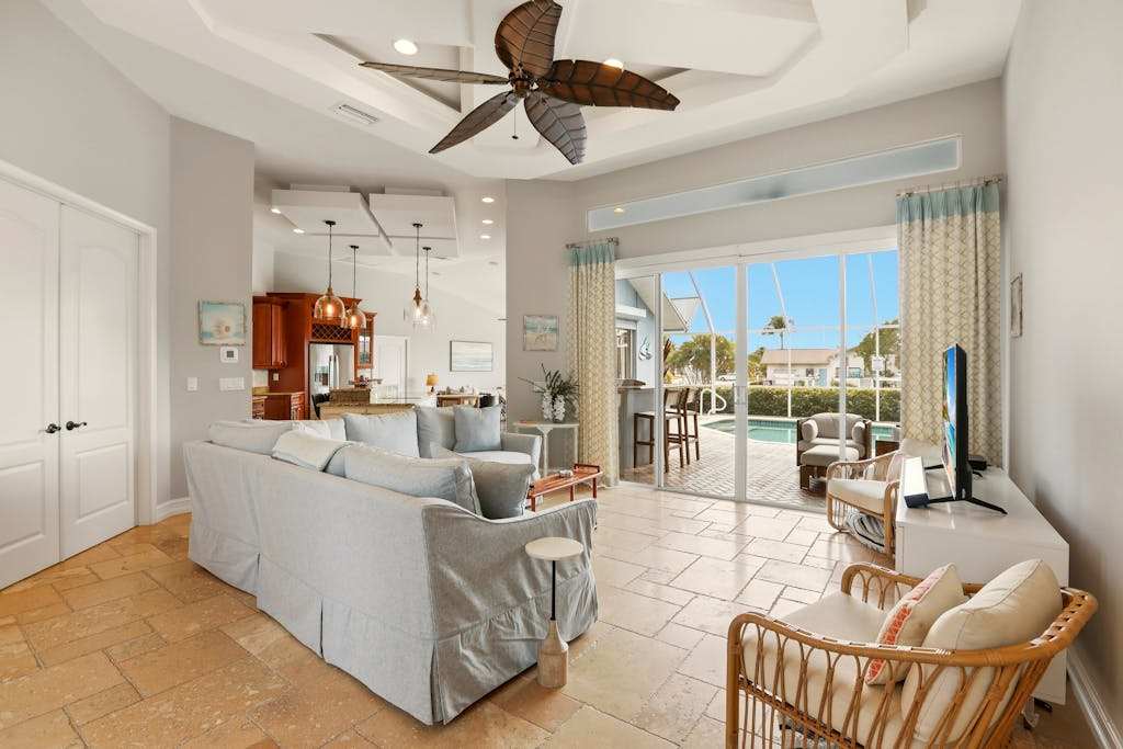 Large corner lot home with canal views & screened in pool close to the beach