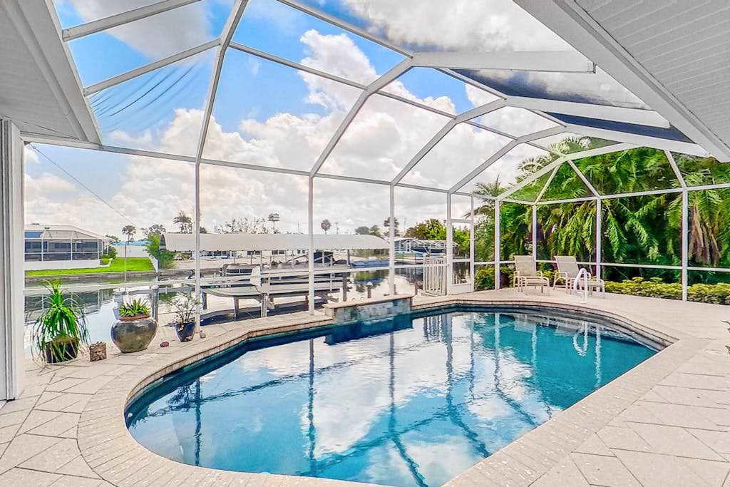 Dog friendly waterfront home with heated pool lanai central AC & washer & dryer