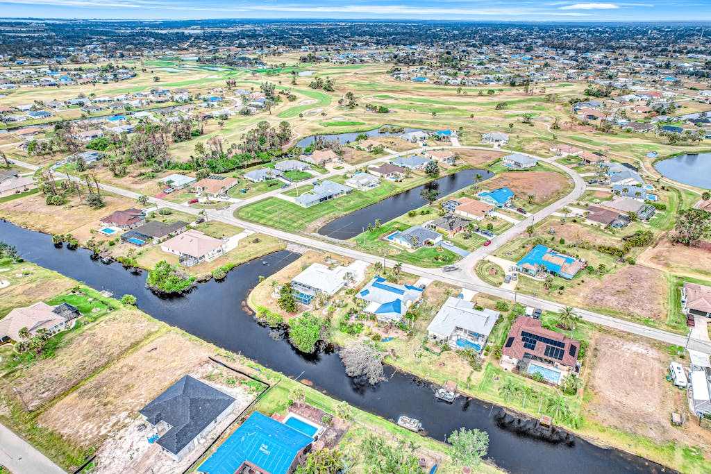 Palm lined waterfront retreat with enclosed pool inviting patio & central AC