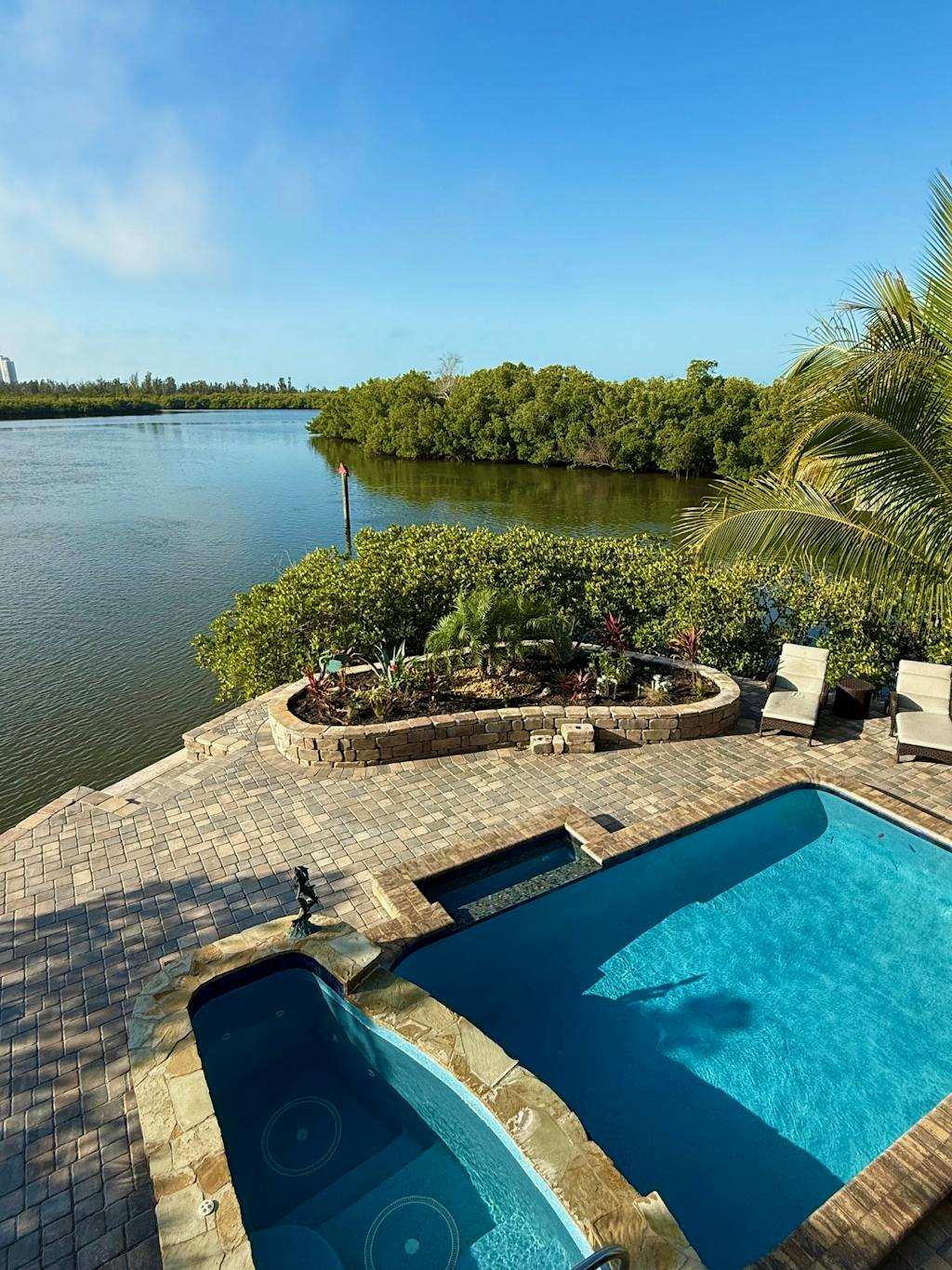 Immaculate bay front home within ground pool spa paver patio & porch
