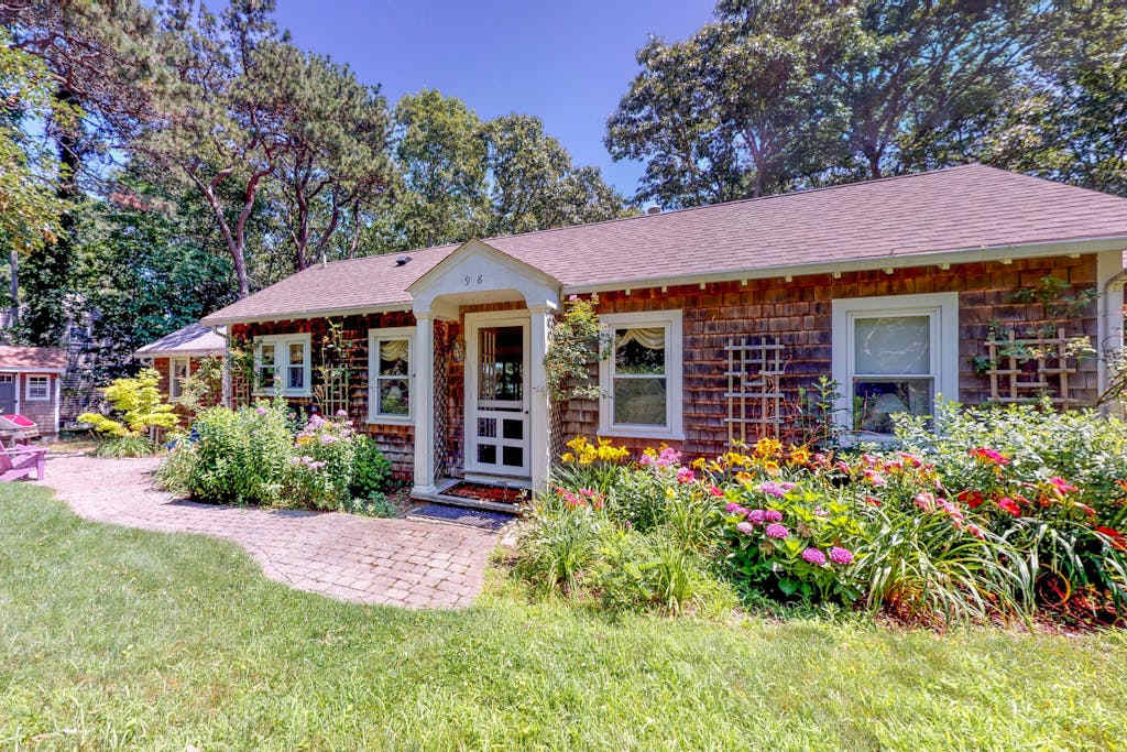 Adorable waterfront home with boat access & a three-season sunroom