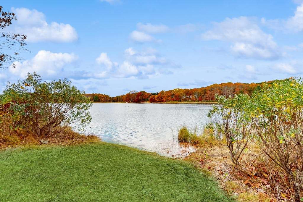 Waterfront Cape house with large deck, fireplace, modern kitchen & grassy yard