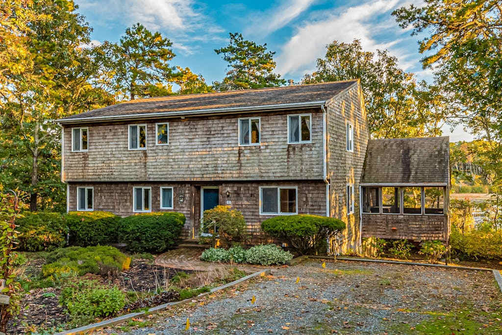 Waterfront home with lovely lake views, great deck, sun porch & fireplace