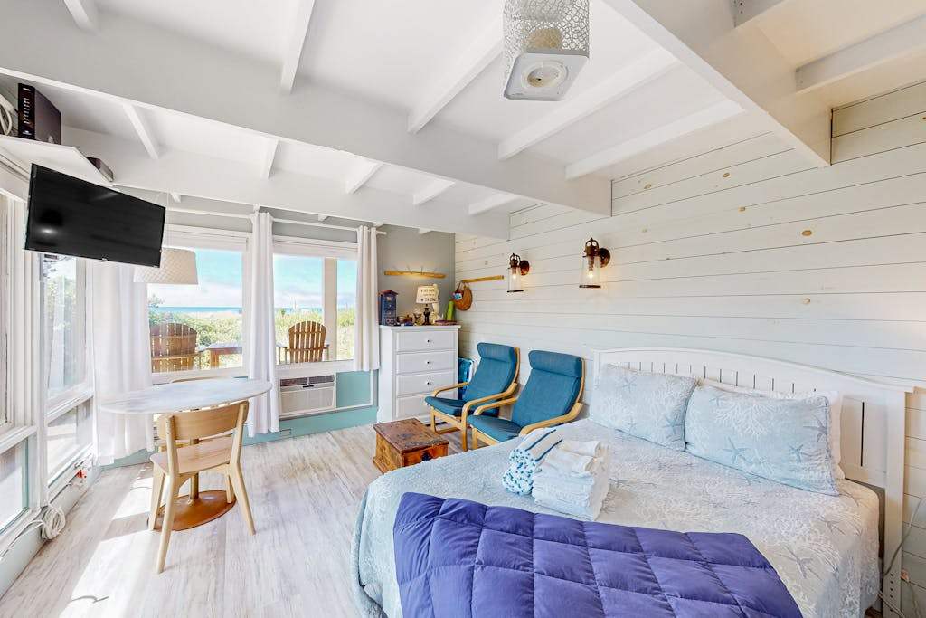 Charming coastal studio with private beach access, scenic patio, grill, & games