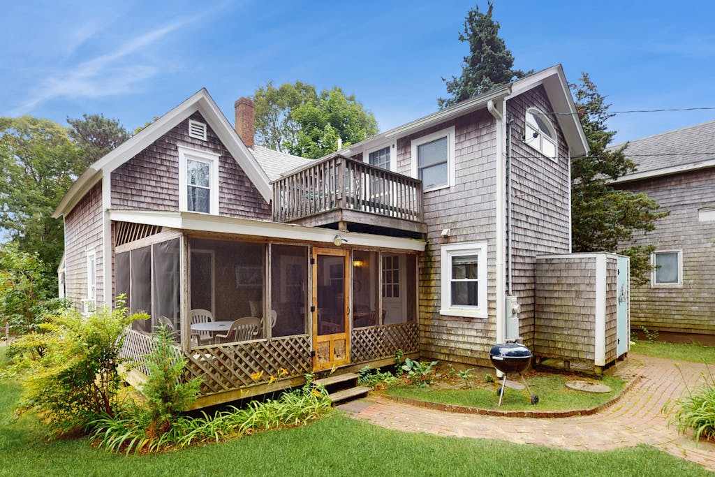 Inviting, two-story home with a large yard, sunroom, balcony