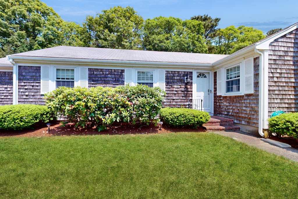 Charming coastal home near pond with sunroom, open layout, yard & AC