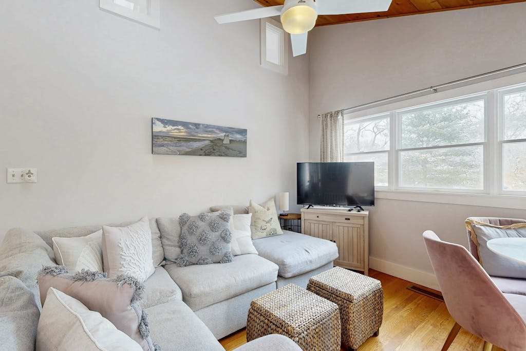 Stylish island retreat with sunny interiors, wraparound deck, firepit & AC