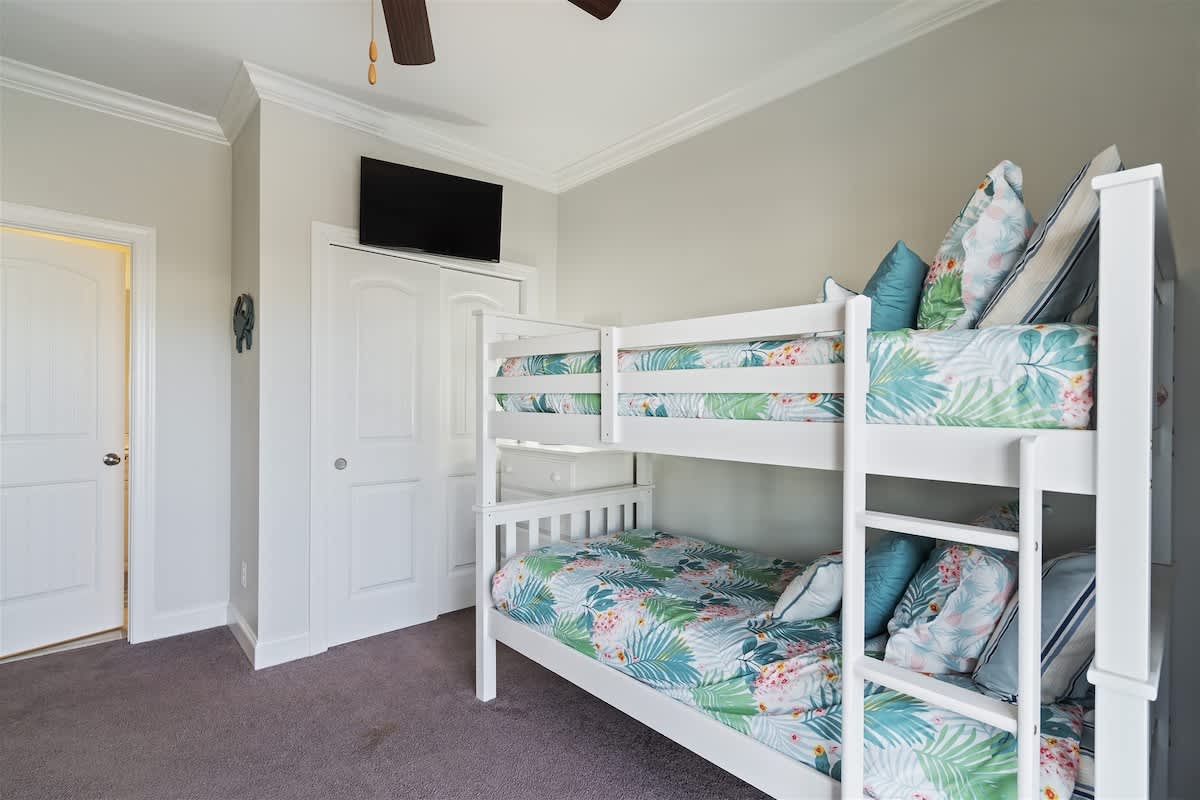 Comfort meets convenience in this bunk room with 4 twin beds and an en suite bathroom for privacy.