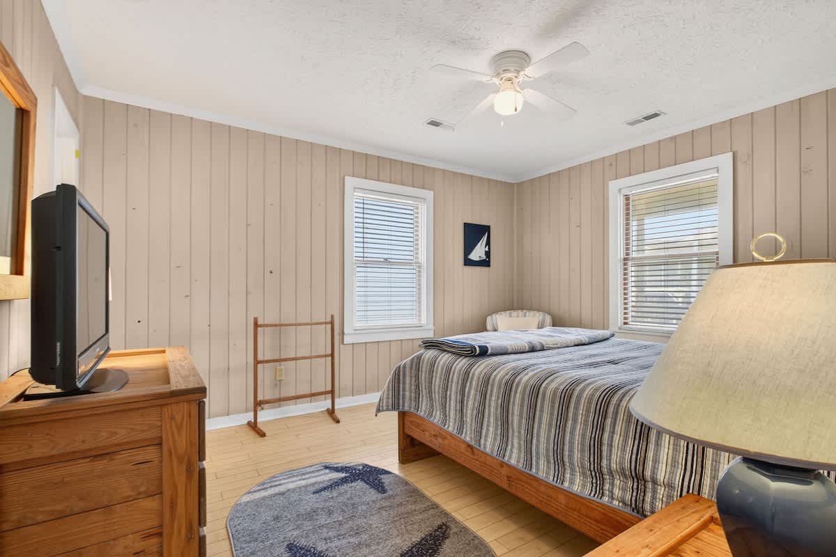 Bright and spacious queen bedroom designed for restful beach nights