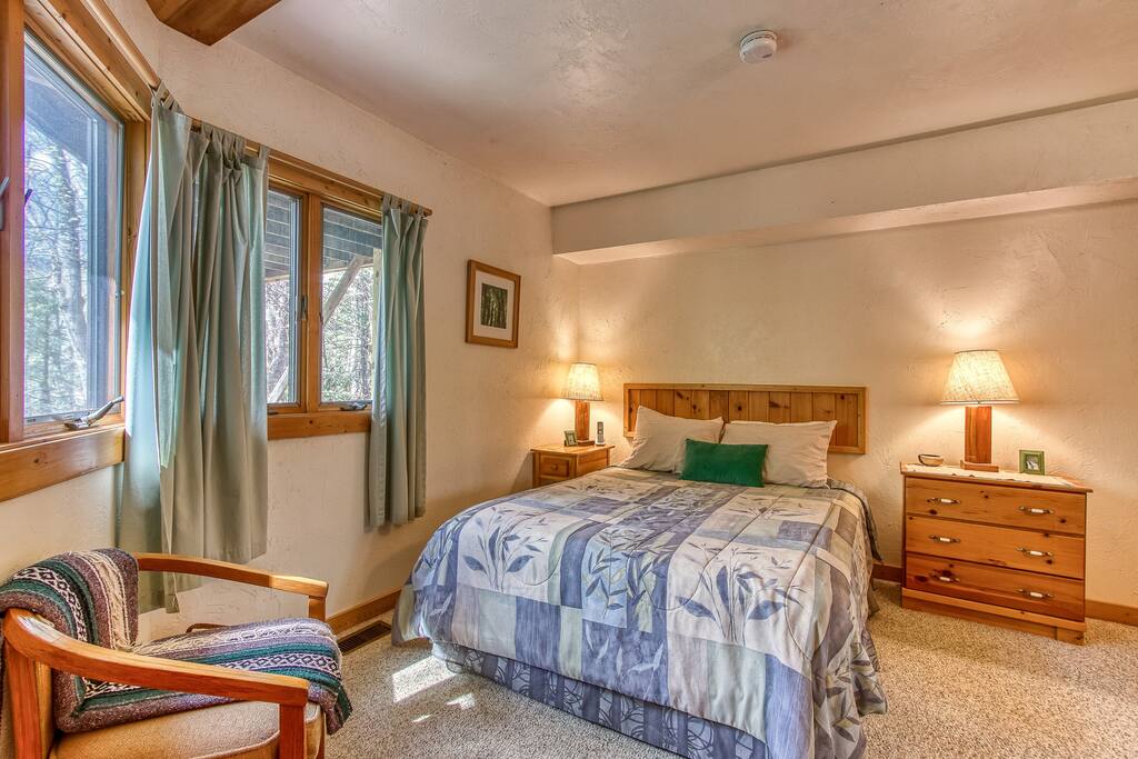 Queen bed in the guest room with soft linens and peaceful ambiance.