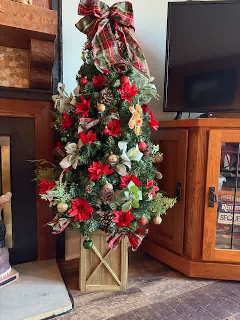 Celebrate the season with this vibrant, beautifully adorned Christmas tree area!