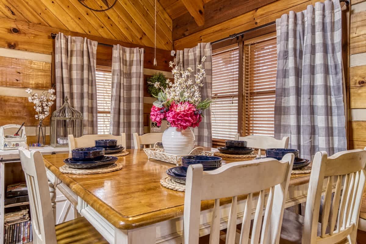 Dining Room: Enjoy delightful meals at this charming wooden table surrounded by rustic decor!
