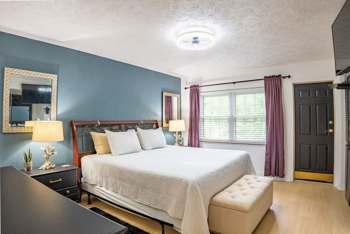 Charming Bedroom: Bright space with elegant decor and plush bedding for restful nights in Gatlinburg!