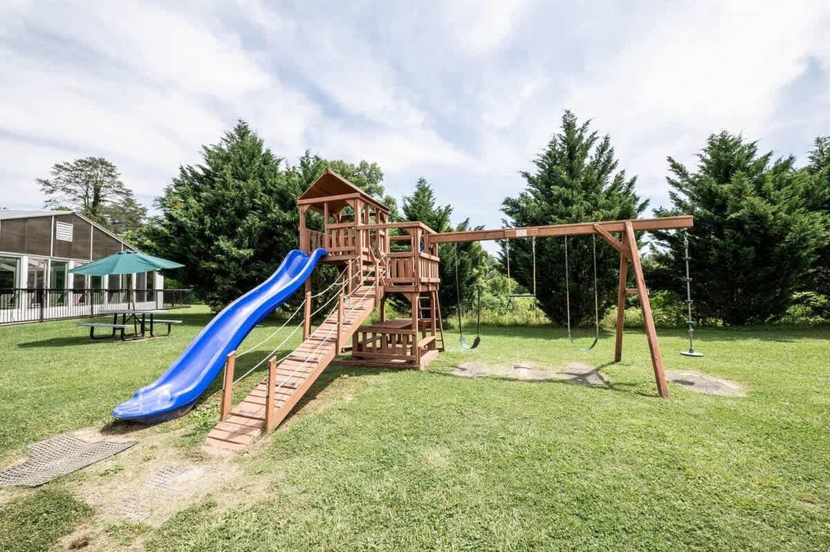  Kids will love this fun-filled play area with swings and a thrilling slide!
