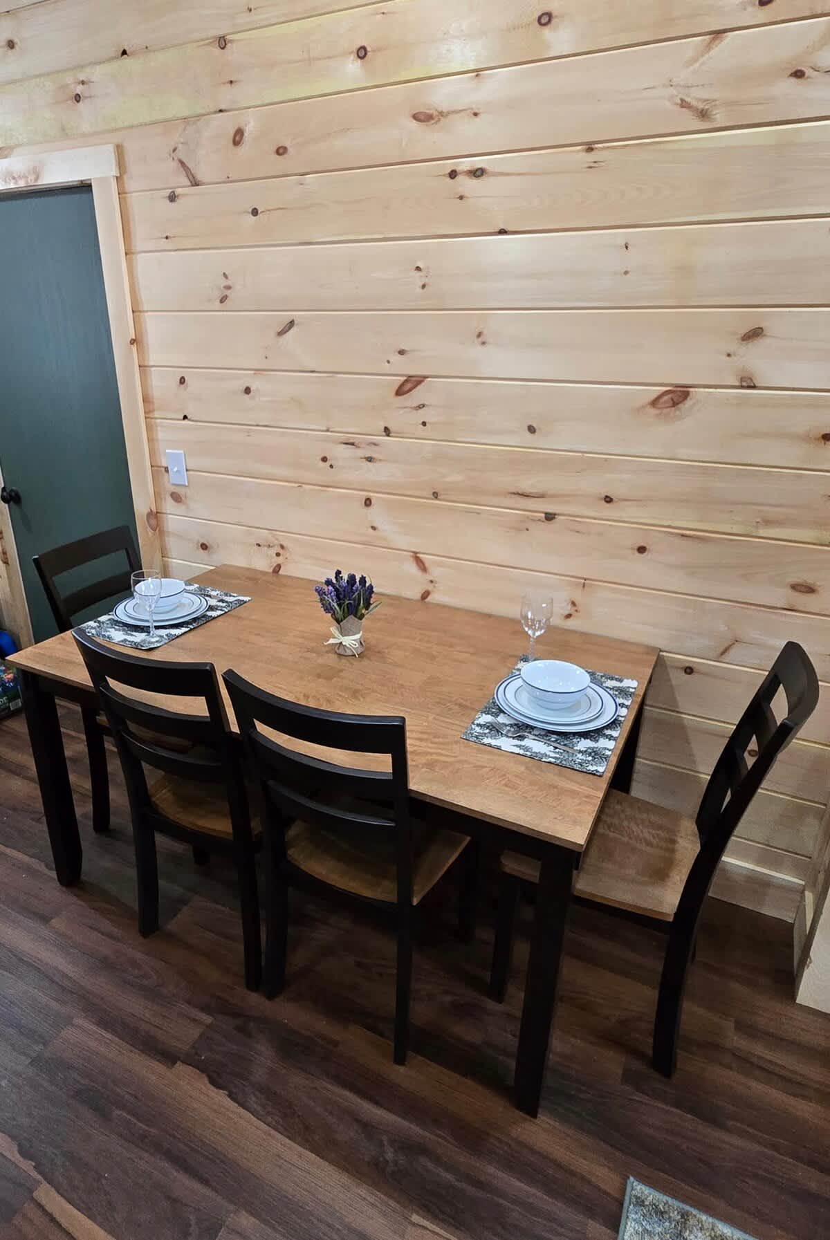 Enjoy delightful meals at this charming wood table with a view of nature!