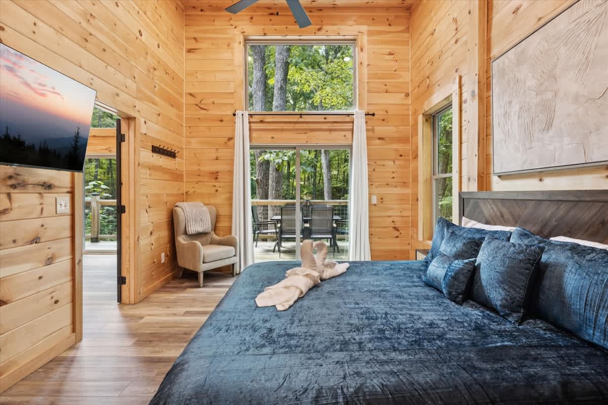 Primary Bedroom: Breathe in nature's beauty from your plush retreat with stunning forest views!