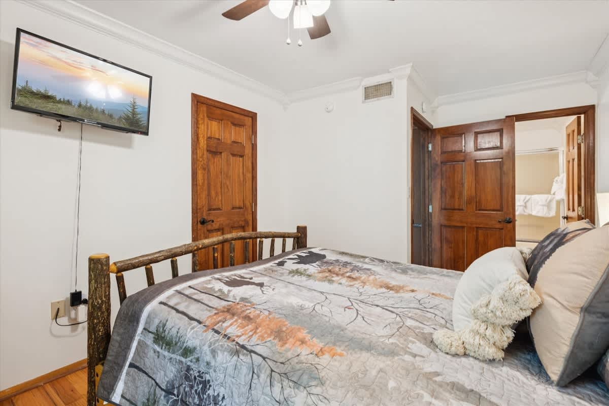 Rustic Retreat: Enjoy mountain views from this charming room with unique log furniture!