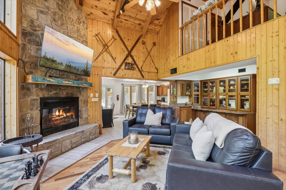 Living Room: Relax by the stone fireplace and enjoy stunning views from every angle!