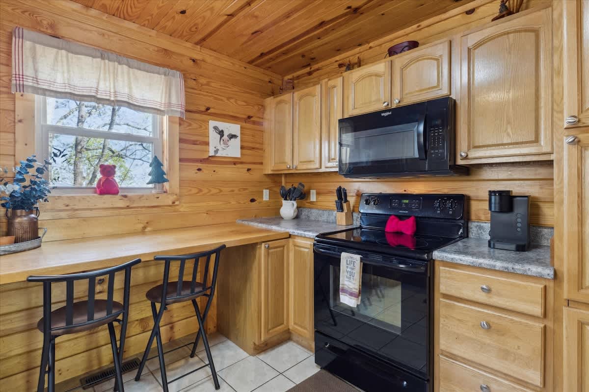 Whip up culinary delights in this charming, wood-paneled kitchen with scenic views!