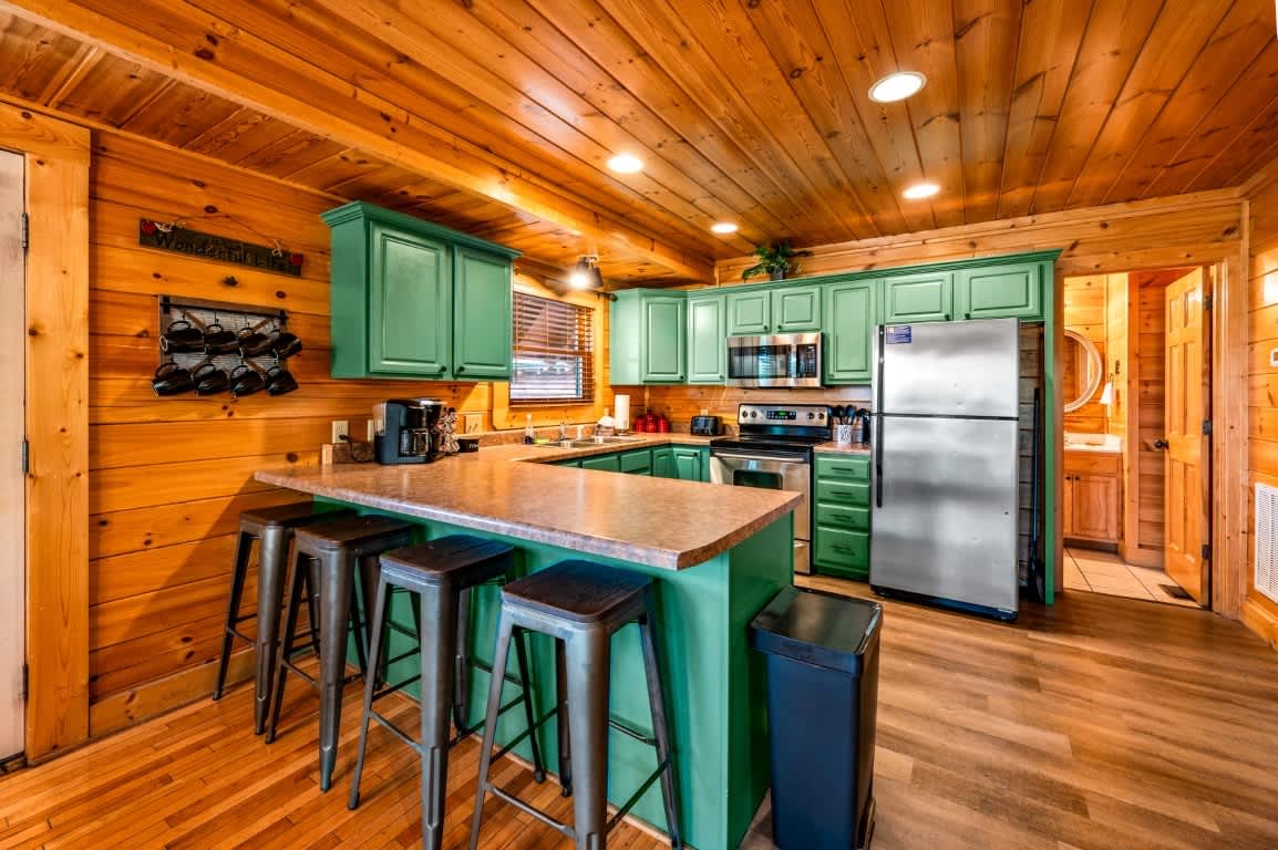 Bright and inviting space with vibrant green cabinets, perfect for culinary adventures!