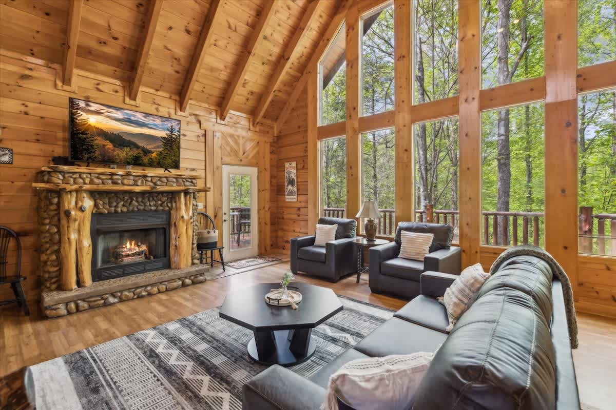 Living Room Retreat: Bask in sunlight with stunning views and a warm fireplace ambiance!