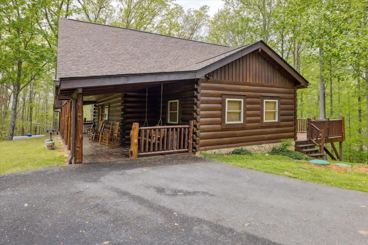 Outdoor Retreat: Enjoy peaceful rocking chairs on the porch surrounded by nature's beauty!