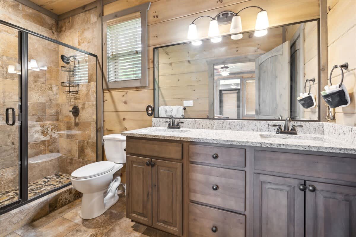 Primary Ensuite:  Luxurious spa-like retreat with stunning stone finishes and modern fixtures!