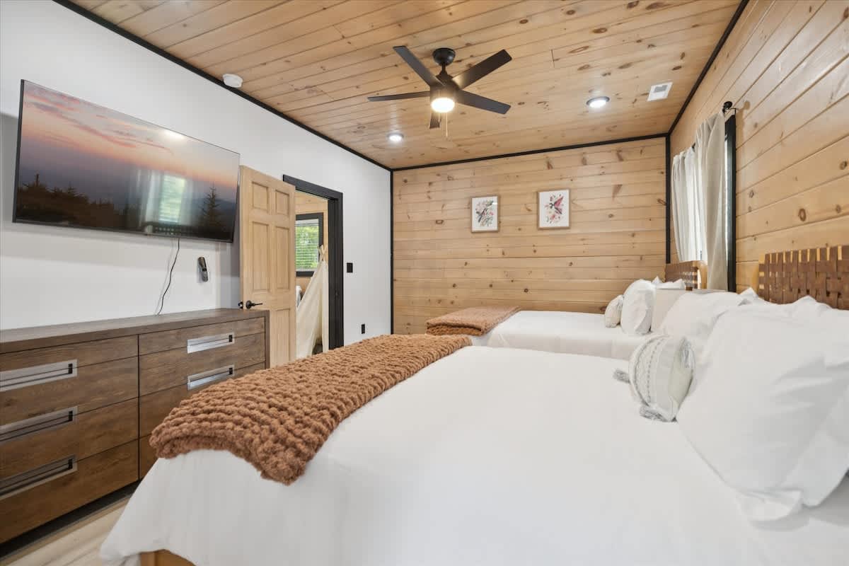 Guest Room: Charming twin beds with rustic charm, bright natural light, and delightful decor!