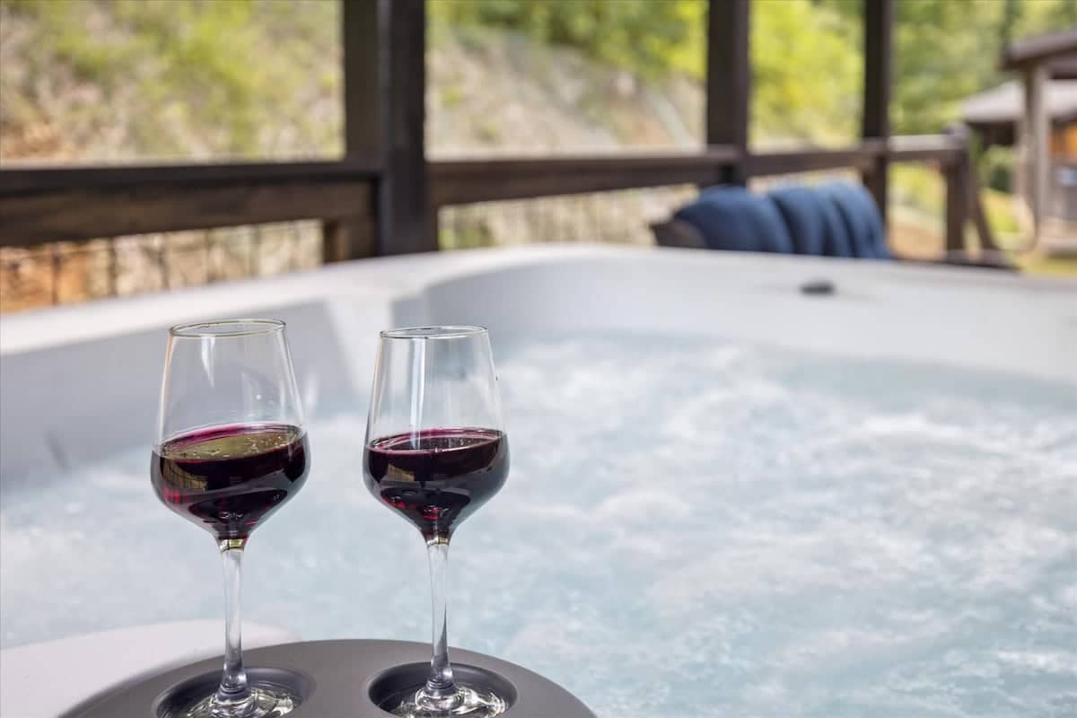 Hot Tub Escape: Unwind with stunning views and a glass of wine in your private hot tub!