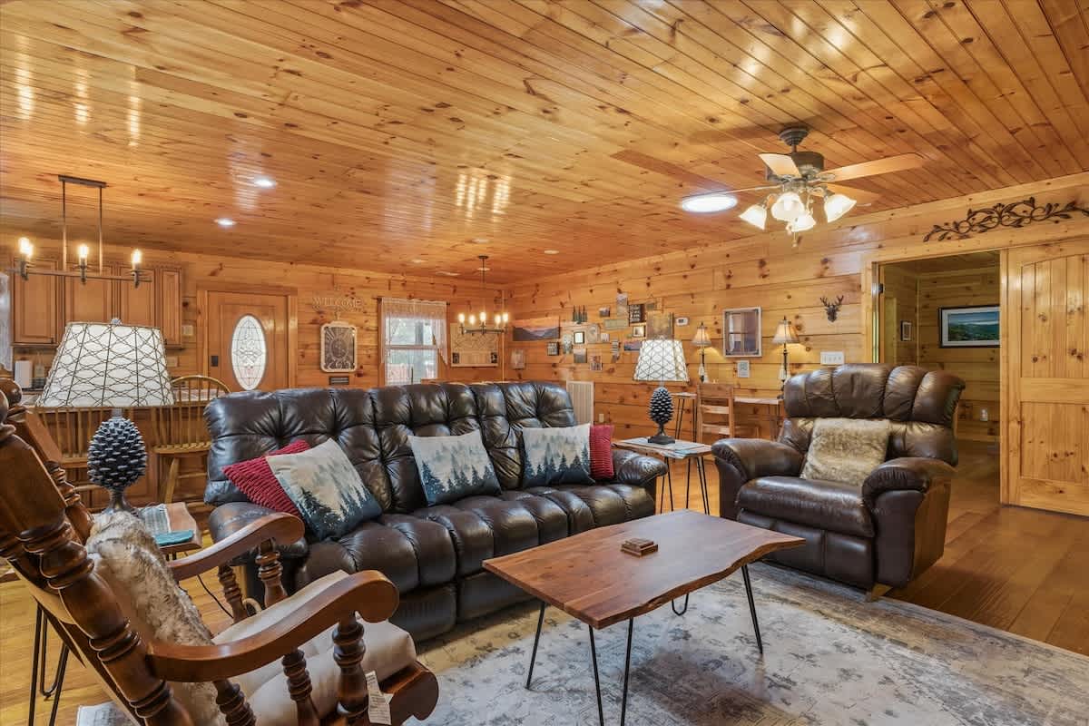 Living Room: Relax in style with leather seating and rustic charm amid custom wood accents!