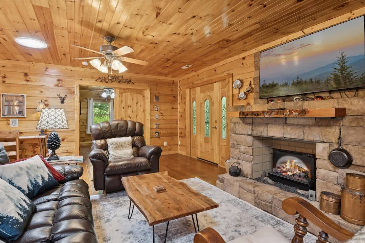 Warm wood tones and a stone fireplace create the perfect gathering spot for fun!