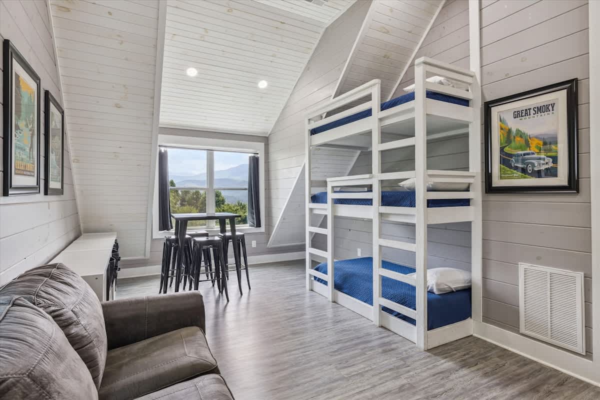 Kid-friendly loft with triple bunkbeds and entertainment zone.