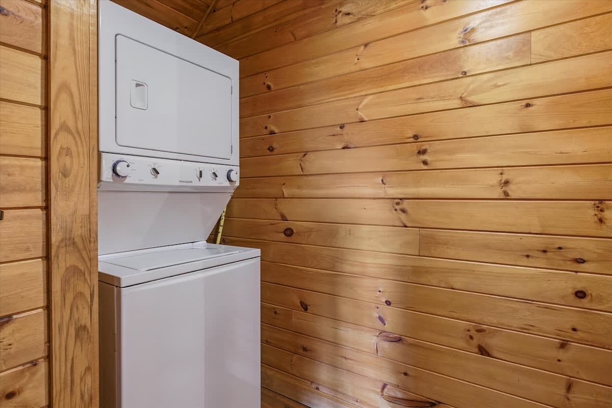 Intimate Bedroom Retreat: Rustic charm with wooden walls and inviting decor for a peaceful getaway!