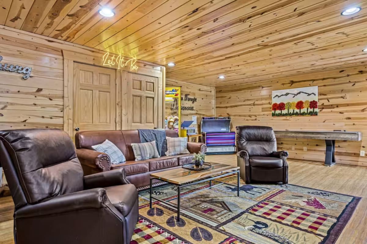 Downstairs media/game room with arcade games and shuffleboard.