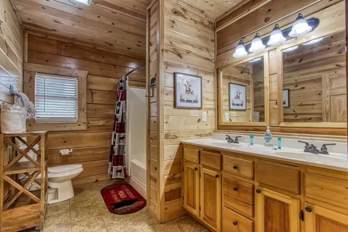 En-suite bath with dual vanities and separate shower/tub combo.
