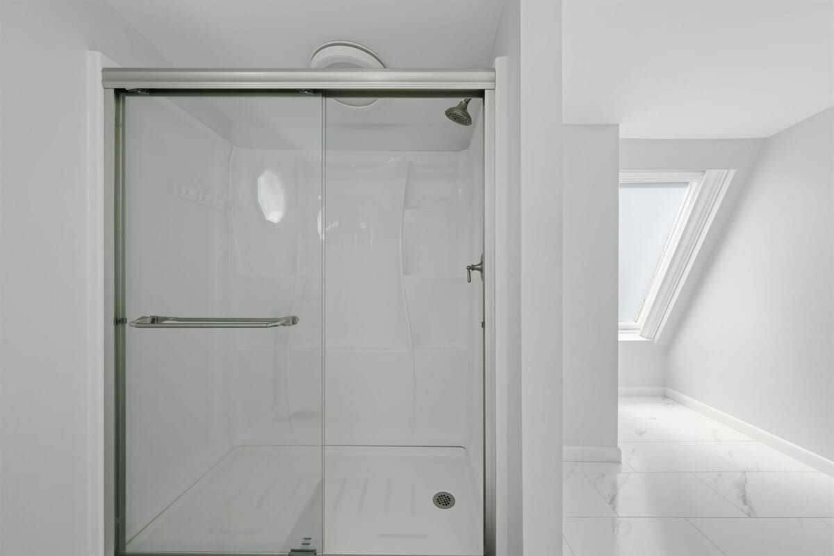 Enjoy a sleek glass shower and bright, airy design for refreshing moments!