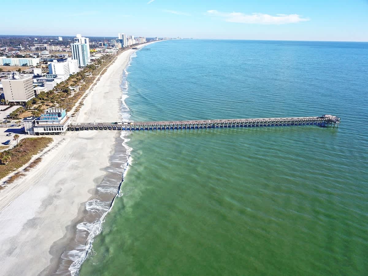 - Aerial view of long pier stretching over the Atlantic Ocean waters   - Iconic Myrtle Beach attraction steps from your vacation rental stay   - Guests enjoy fishing, strolling and panoramic views from the pier