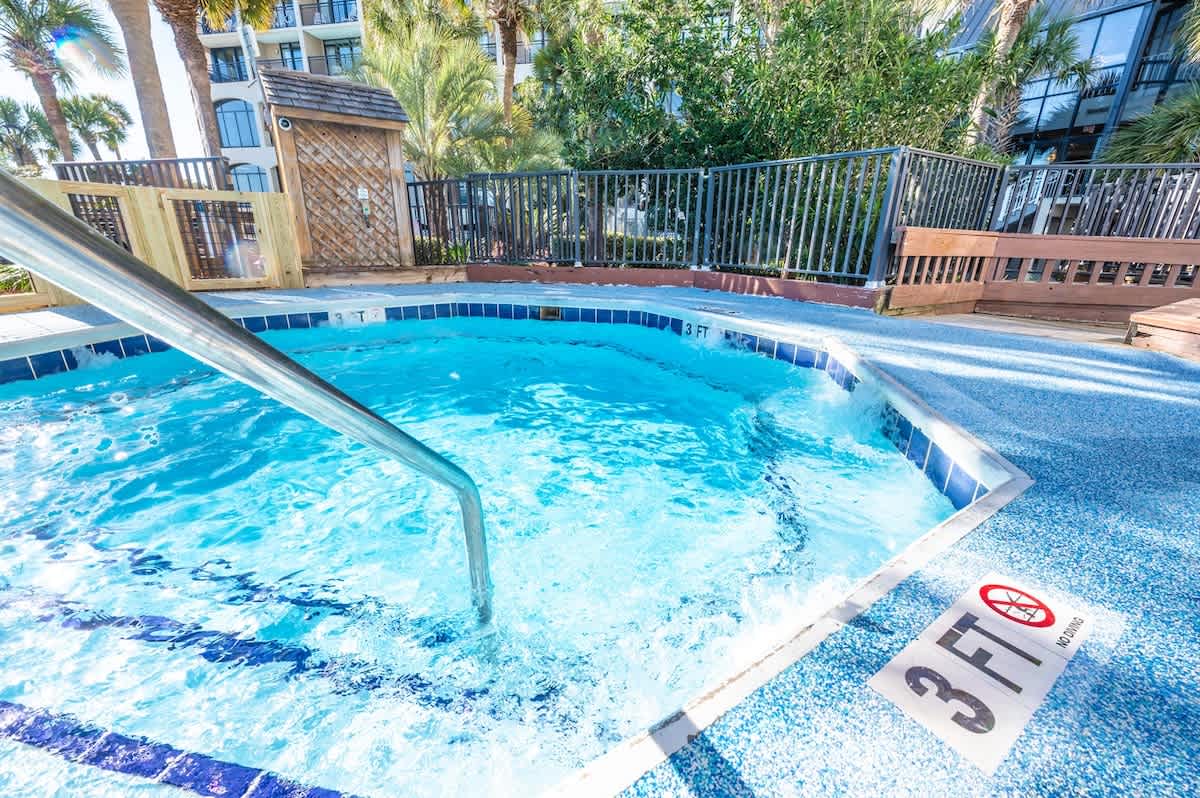 - Inviting hot tub with bubbling water and comfortable seating area   - Ideal for relaxing after beach adventures or evening swims   - Peaceful amenity designed for unwinding throughout your stay