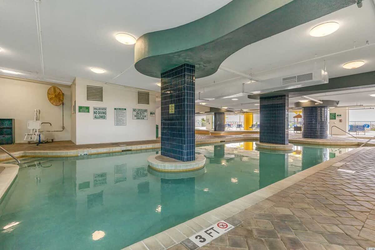 Indoor pool with unique architectural columns and a relaxed atmosphere.