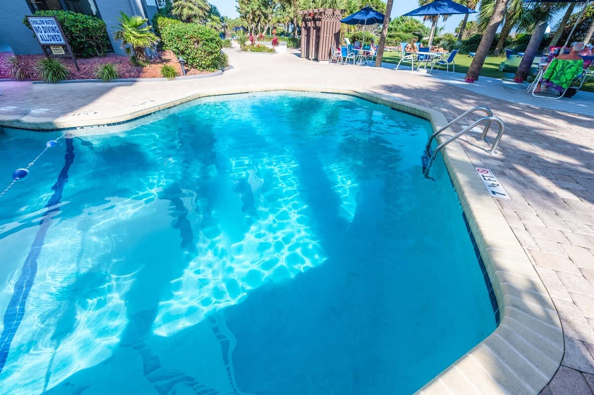- Large swimming pool with refreshing waters and sun loungers   - Perfect for a morning swim or cooling off in the afternoon   - Surrounded by lush landscaping for a relaxing setting