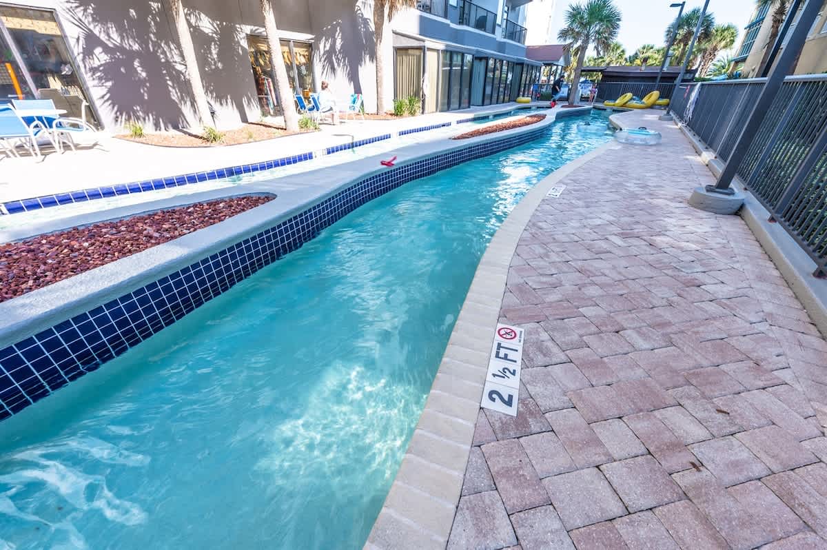 - Family-friendly lazy river pool with spacious seating areas   - Shallow water perfect for floating, lounging, and relaxing   - Popular resort feature loved by both kids and adults alike