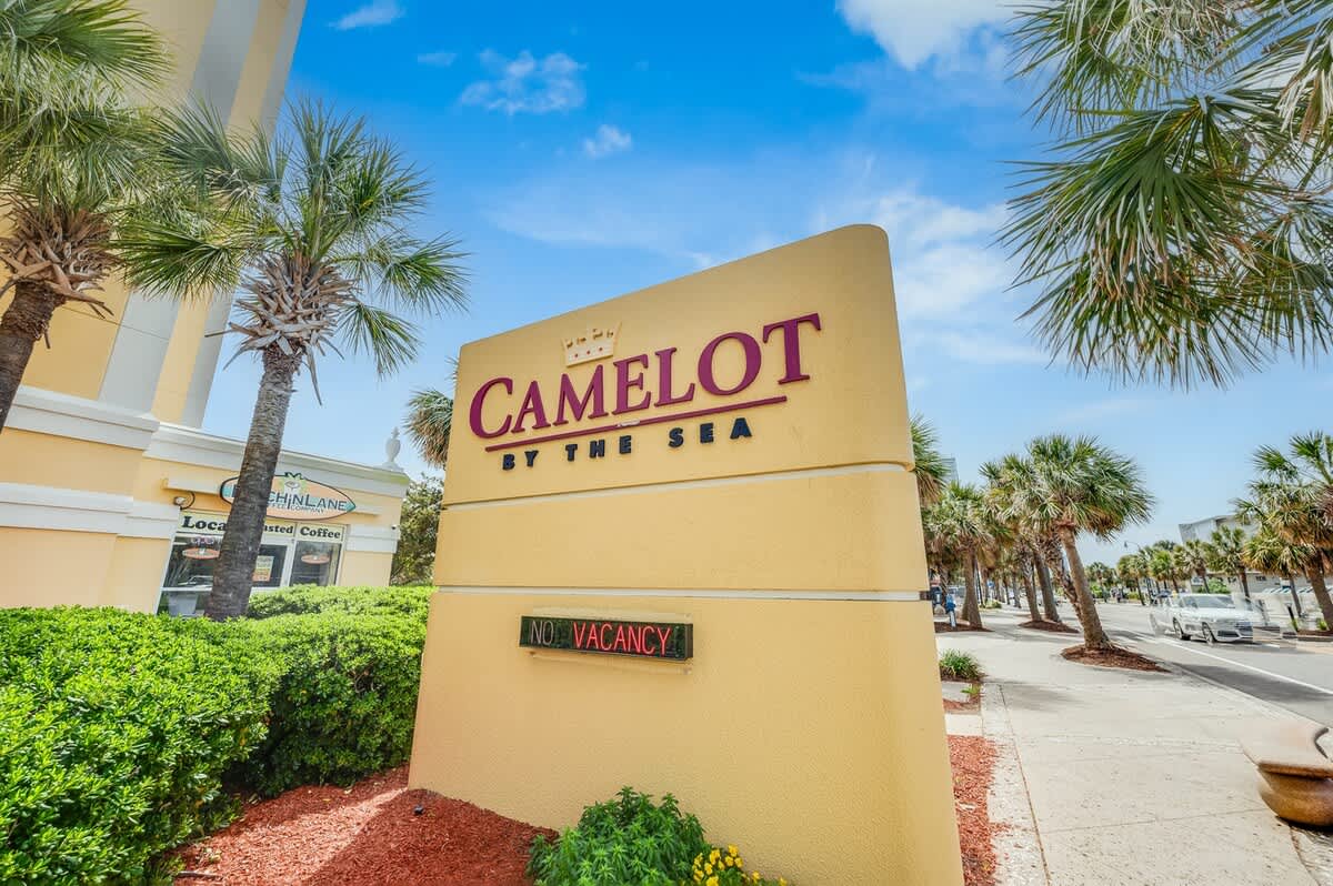 - Camelot by the Sea resort sign at entrance   - Recognizable landmark for Myrtle Beach vacations   - Welcoming start to your oceanfront stay experience