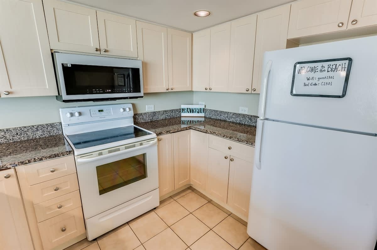 - Kitchen includes oven, microwave, and full fridge for extended stays   - Plenty of cabinet space for groceries and essentials during vacation   - Granite countertops offer a clean and stylish coastal cooking setup