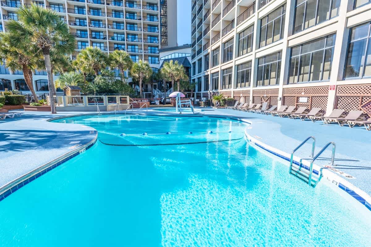 - Expansive resort pool surrounded by palm trees and sun loungers to enjoy   - Easy access for a refreshing dip after a day on the sandy Myrtle Beach   - Perfect for families couples and friends to relax poolside together