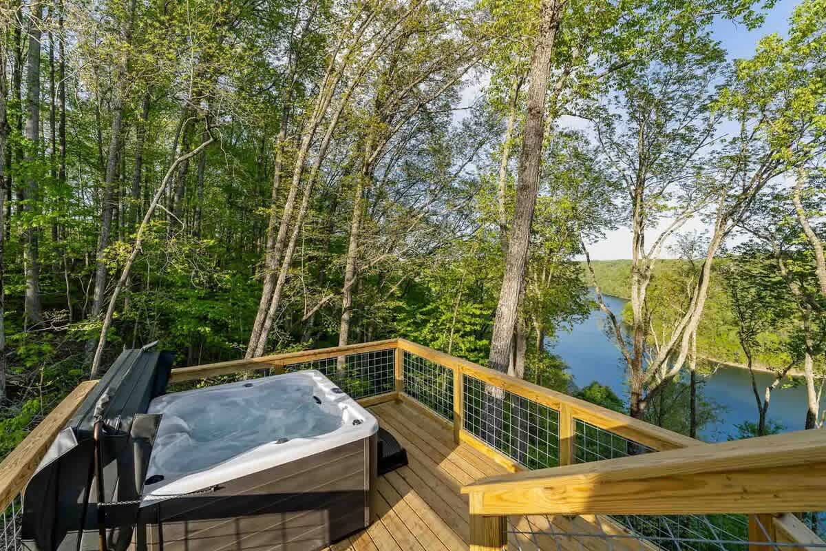 Relax in a private hot tub overlooking the trees and Center Hill Lake, perfect for unwinding year-round.