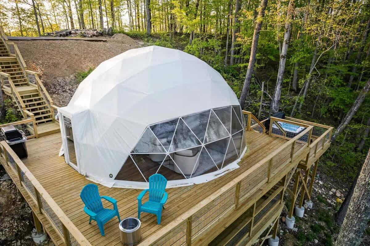 The Burgess Falls Dome with private deck, hot tub, and seating, tucked into the trees above Center Hill Lake.