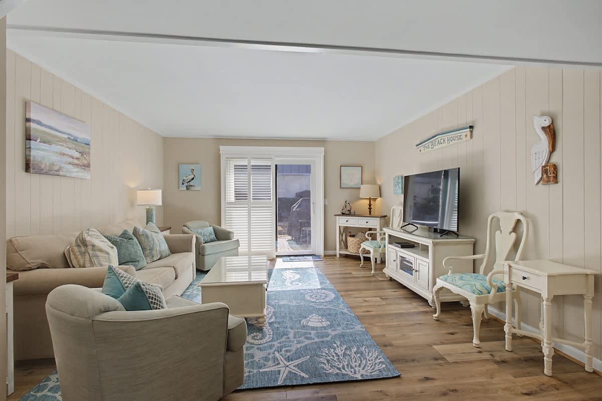 Sink into coastal comfort in your beautifully appointed living room, where soft beach tones and charming nautical touches create the perfect seaside retreat.