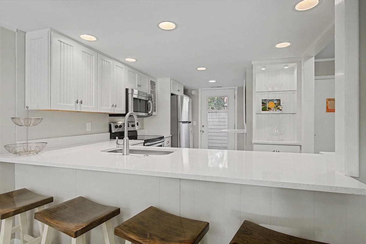 Your bright, open kitchen features gleaming countertops and modern appliances, perfect for whipping up morning coffee or preparing meals together.